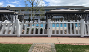 Cellular PVC fencing surrounding a pool.