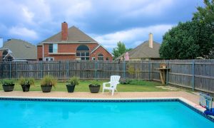 residential pool with fence surrounding it